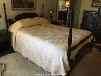 Full view of assembled four-post bed with bedding