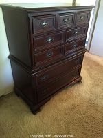 Front view of solid mahogany chest of drawers by Gibbard Craftsmen with nine drawers and bracket feet