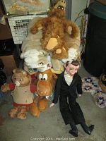 Lot of six plush toys and puppet including Alf, Bullwinkle, bulldogs, Teddy Ruxpin, and Charlie McCarthy puppet shown together for overview.