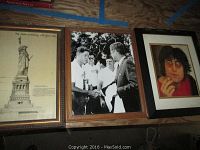 Three framed prints including Statue of Liberty, black and white handshake photo, and John Lennon color photo