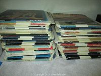 Two stacks of RCA SelectaVision Video Discs in original sleeves shown from the side, displaying thickness and quantity of discs.