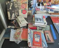 Vintage magazines including TV Radio Mirror, Movie Secrets, and Photoplay arranged on a table with vintage maps and Reader's Digest magazines visible