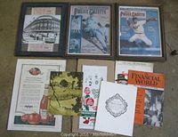 Overhead shot showing all framed prints and loose vintage ephemera spread on floor