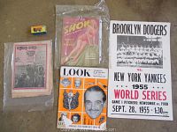 All items laid out on floor showing the World Series poster, magazines, newspaper, and toy car.