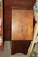 Front view of the wooden potato storage box showing the carved lid design with the word 'Potatoes' and bowl illustration.