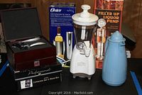 Full view of all items including liquor pump box, Oster electric wine opener box, corkscrew set in wood box, and Smoothie Blast blender.