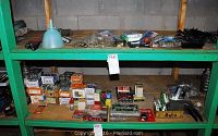 Wide shot of top and middle shelves holding boxes of nails, screws, and small hardware items in packets and containers