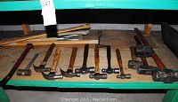 Shelf with multiple hammers, mallets, and a pry bar showing all items in lot