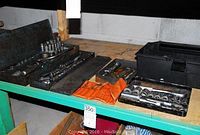 Full shelf view showing multiple socket sets, wrenches, and an orange pouch containing Allen keys.