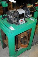 Front and side view of Sears Craftsman 1/2 HP bench grinder mounted on green table, showing grinding wheels and protective shields.