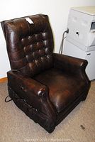 Front view of the brown Naugahyde motorized massage chair showing tufted back and armrests.