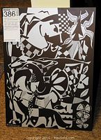 Full view of the 12x16 inch etched aluminum art piece with various black and white abstract motifs including birds, fish, and geometric patterns. Signed by Barbeau on bottom left.