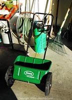 Scotts 1000 broadcast spreader with large wheels, green plastic hopper and black metal frame