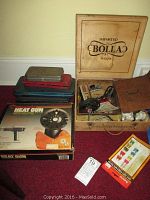 An overview of the lot showing original boxes for the Milwaukee heat gun, various ratchets and sockets in a wooden box, and the power timing light gun.