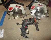 Two Craftsman circular saws and one Skil hammer drill arranged on floor, showing general condition and overall view of lot.