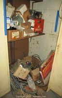 Boxes and loose electrical wiring on floor with a variety of electrical components and packaging including Phillips bulbs and Abbott box.