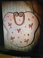 Top view of lava splatter ceramic dish shaped irregularly with floral and colored dot decorations