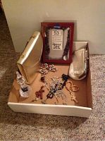 Photo of rosary beads, two gold-tone purses, small crystal vase and box containing items