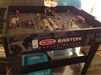 Overall view of Easton hockey-soccer table game standing on legs, shows side Easton branding and detail.