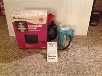 Beckett fountain pump box and used Little Giant pump side by side on carpet