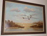 Frontal view of oil painting showing lakeside landscape with boat, birds in flight, and surrounding vegetation under a partly cloudy sky.