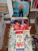 Photo showing Elton John, Gloria Estefan, and April in Paris records on top of one box with other records behind and around.