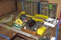 Overview of lot items on workbench including saws, sanding block, pencil sharpener, and hardware drawers.