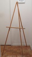 Full view of oak tripod easel standing upright, showing overall design and finish.