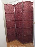 Full view of the burgundy fiber weave 3-panel adjustable room divider showing the arched top edges and connected panels.