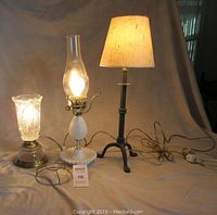 Photo showing all three lamps illuminated and arranged on a flat surface, visualizing height and style differences.