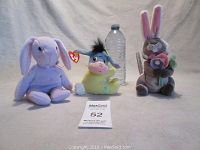 Wide view of all three plush toys together with a water bottle for scale: Ty Floppity Beanie Baby, Fisher Price Eeyore, and Disney Store Gopher