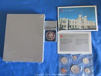 Full view of the lot including the three coin collections and notable packaging.