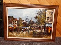 Full view of the framed oil painting showing an urban street scene with pedestrians and historic buildings under a cloudy sky.