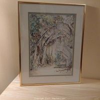 Framed watercolour painting showing a banyan tree entwined with wooden staircase. Signed by the artist, with double mat and gold frame.