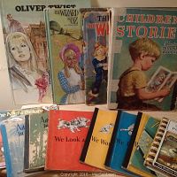 Photo showing several vintage children’s books including Oliver Twist, The Wizard of Oz, Children Stories, and several smaller illustrated books.