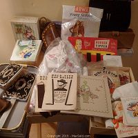 Full view of the lot showing boxed stockings, hat holders, a brown leather case, fabric pouches, and greeting cards on a table.