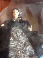 Front view of Catherine Parr Peggy Nisbet doll in original box allowing clear view of the doll's face and detailed dress.