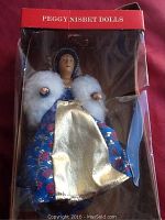 Full shot of Peggy Nisbet Anne Boleyn doll in original box showing blue and gold dress with white fur collar