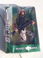 Front view of sealed G.I. Joe Desert Grenadier action figure in original packaging showing the figure in desert camouflage holding a rifle.