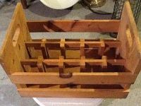 Front view of the locally made wooden wine crate showing multiple dividers for holding bottles securely.
