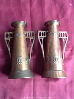 Pair of vases side by side on fabric background