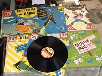 Photo of seven vintage children's vinyl record covers and one record outside sleeve showing wear and colorful illustrations