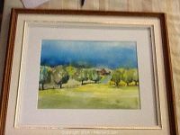 Framed watercolour painting showcasing the full artwork within the brown wooden frame with gold inner edge and white matting, overall size 17 by 15 inches.