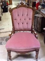 Front view of the East Lake antique chair upholstered in pink velvet showing tufted back, wooden carved frame, and padded seat.