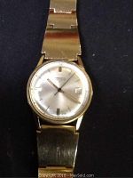 Front face view of Pomponnette Rotomatic men's watch showing silver dial, gold-tone markers, hands, and date window.