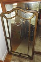 Full view of the vintage arched mirror with intricate reverse floral etching and ornate gold-toned wooden frame