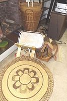 Overall view showing multiple woven baskets near fireplace and two rugs, including round woven rattan rug.