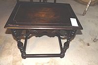 Full top view of the table showing the wood finish and wear on surface.