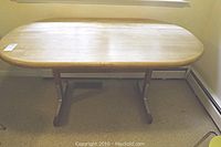 Solid pine wood rectangular kitchen table with rounded corners and smooth top surface, two legs with stretcher bars in good condition.