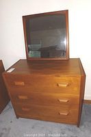 Full view of the teak veneer dresser with three drawers and mirror on top, showing dimensions and overall condition.